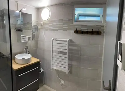a small bathroom with a sink and a mirror at La Ferme l'Etang in Vachères