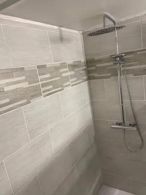 a bathroom with a shower with a shower head at La Ferme l'Etang in Vachères