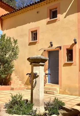 a water fountain in front of a building at Mas du Clos , Tilleul in Roussillon