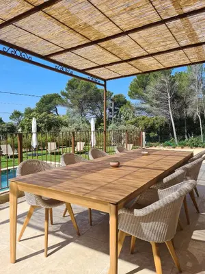 a wooden table and chairs under a wooden umbrella at Villa de luxe en Luberon - Piscine chauffée in Puget