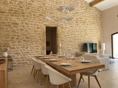 a dining room with a wooden table and chairs at Villa de luxe en Luberon - Piscine chauffée in Puget