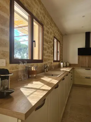 a large kitchen with a sink and a window at Villa de luxe en Luberon - Piscine chauffée in Puget