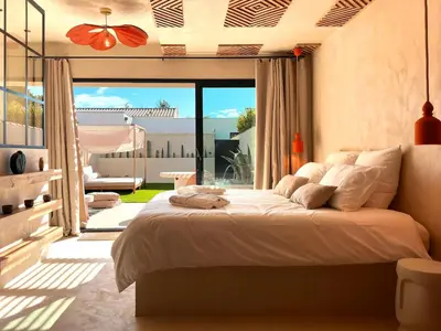 a bedroom with a large bed and a balcony at Love in L'Isle/Sorgue L'Aurore in LʼIsle-sur-la-Sorgue