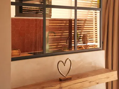 a heart statue on a window sill in front of a window at Love in L'Isle/Sorgue L'Aurore in LʼIsle-sur-la-Sorgue