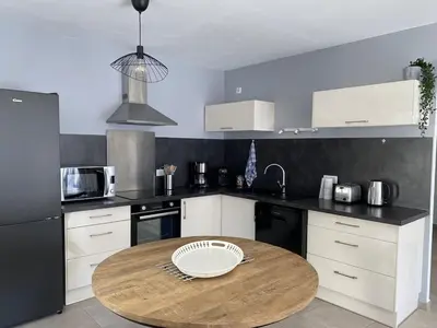 a kitchen with a wooden table in the middle at Moun Cabanoun in Carpentras