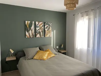 a bedroom with a bed with a yellow pillow on it at Moun Cabanoun in Carpentras