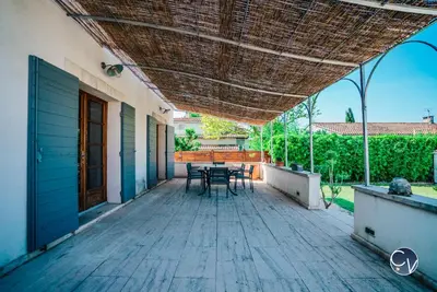 a patio with a table and chairs on it at Villa le Thor Piscine Billard Sauna et Jacuzzi in Le Thor