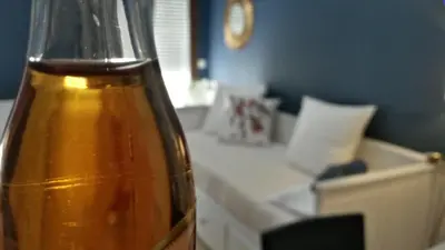 a bottle of oil sitting on a table with a counter at Centre d'Aix - charmant appartement 1 chambre Pythagore avec parking in Aix-en-Provence
