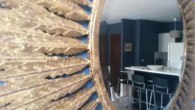a mirror reflection of a kitchen with a counter in a room at Centre d'Aix - charmant appartement 1 chambre Pythagore avec parking in Aix-en-Provence