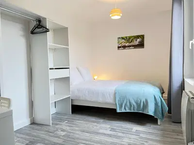 a bedroom with a bed and a book shelf at AptCityStay in Apt