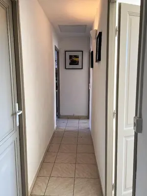 a hallway with a tile floor and a white door at AptCityStay in Apt