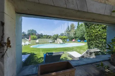 a window view of a yard with a swimming pool at Gite Grand Luberon chez Manon en Luberon - Vacation rental in guest house in Lagnes