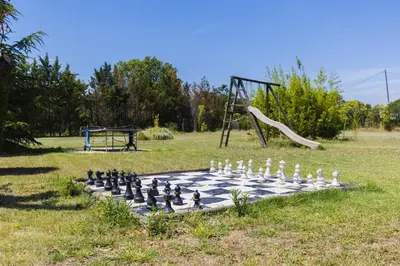 a chess board and a slide in a park at Gite Grand Luberon chez Manon en Luberon - Vacation rental in guest house in Lagnes