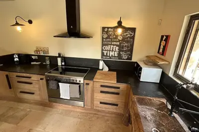 a kitchen with a stove and a counter top at La Terrasse Collongue in Lourmarin
