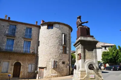 a statue in front of a building with a building at LA JOVINE 2 Sault in Sault-de-Vaucluse
