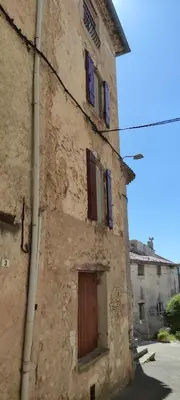 an old stone building with a door and windows at LA JOVINE 2 Sault in Sault-de-Vaucluse