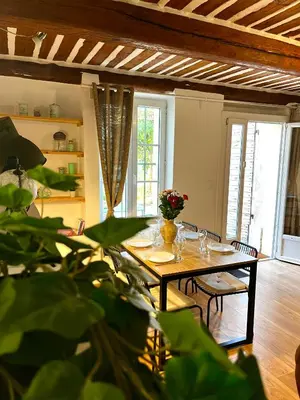 a kitchen with white cabinets and a tile floor at Le Mas d’Aloha in Plan-dʼOrgon