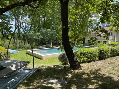 a swimming pool in a yard with a tree at Ermitage Notre Dame de Vacquieres in Noves