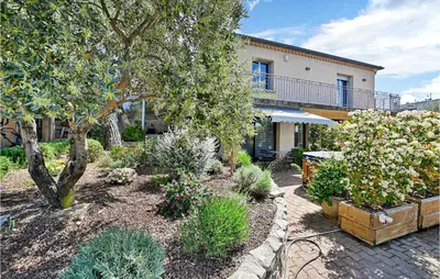 a garden with flowers and plants in front of a house at 2 Bedroom Amazing Home In Châteaurenard in Châteaurenard