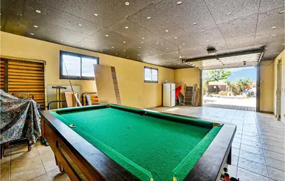 a pool table in the middle of a room at 2 Bedroom Amazing Home In Châteaurenard in Châteaurenard