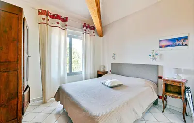 a bedroom with a bed and a window at 2 Bedroom Amazing Home In Châteaurenard in Châteaurenard