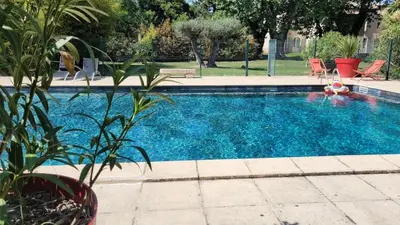 a swimming pool with blue water in a yard at Bastide Sainte Marie in Mallemort