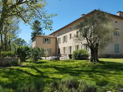 a large house with a tree in the yard at Bastide Sainte Marie in Mallemort