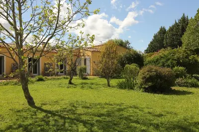 a house with a yard with green grass and trees at Bastide Magnolia - Gite et chambres d 'hôtes Les dépendances, Roussillon in Roussillon