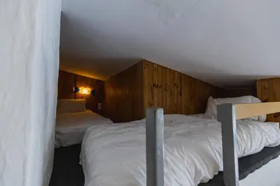 two beds in a room with wooden walls at Chambre d'hôtes - B&B - Grand Luberon chez Manon en Luberon in Lagnes