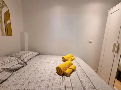a yellow stuffed animal sitting on top of a bed at T2 Centre Historique Rénové in Aix-en-Provence