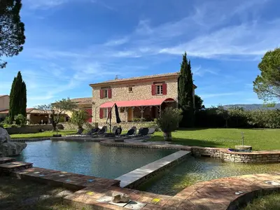 a house with a pond in front of it at La Meynardière in Saint-Pierre-de-Vassols