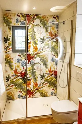 a shower stall in a bathroom with a floral wallpaper at Le chant des jardins in LʼIsle-sur-la-Sorgue