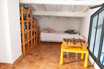 a bedroom with a bunk bed and a table with a chessboard at Le chant des jardins in LʼIsle-sur-la-Sorgue