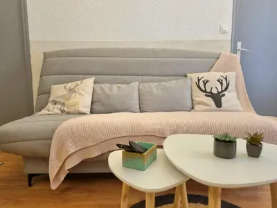 a couch with pillows and a table in a living room at Appartement centre historique in Aix-en-Provence