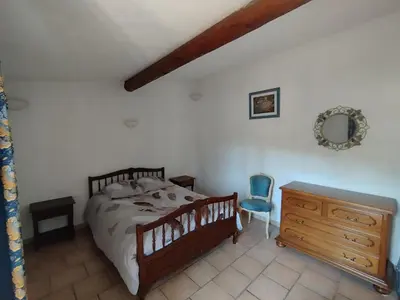 a bedroom with a bed and a dresser and a mirror at L' ABBADIE in Carniol