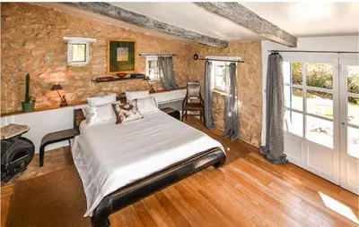 a bedroom with a bed and a desk and windows at Gorgeous Home In Sault in Sault-de-Vaucluse