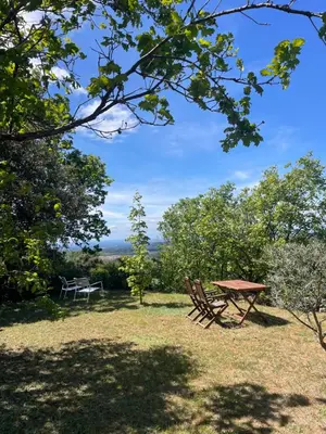 a picnic table and a bench in the grass at Magnifique villa -piscine privée vue Mont Ventoux in Malemort-du-Comtat
