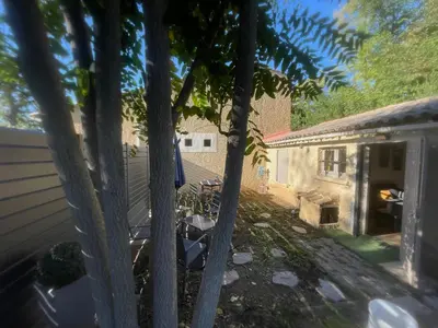 a group of trees in front of a house at Jolie petite maison Avignon - Montfavet in Montfavet